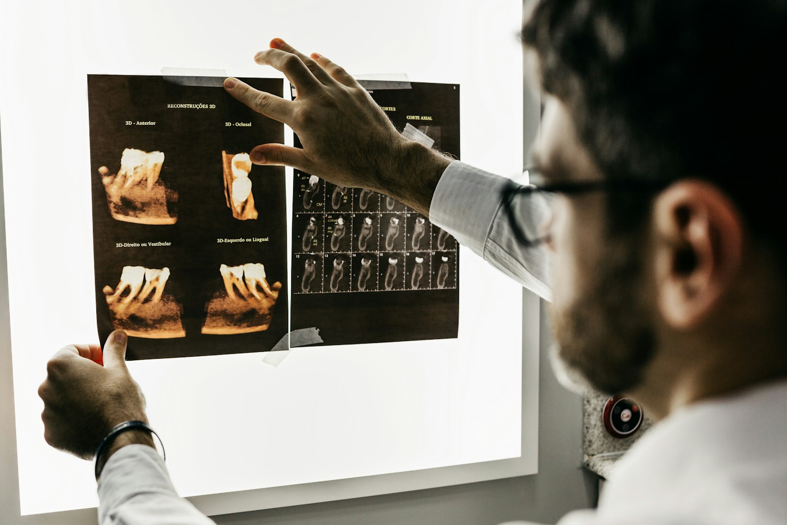 A clinician reviewing a dental radiograph